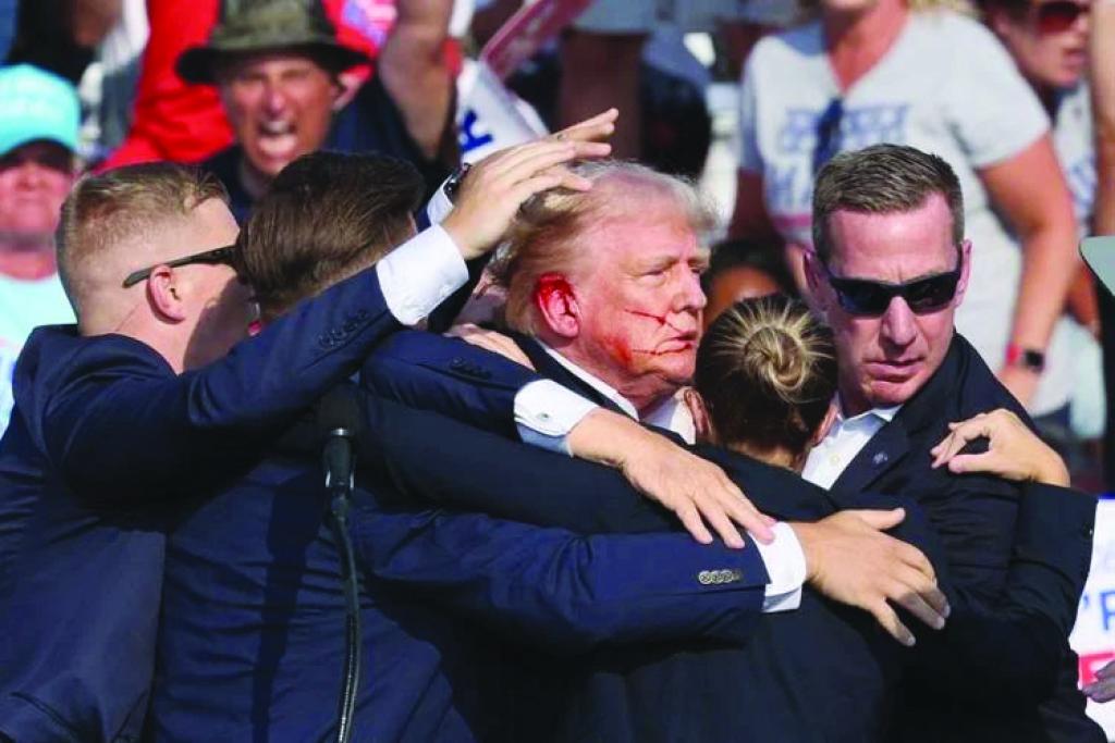 Bloodied Trump 'safe' after shots fired at rally